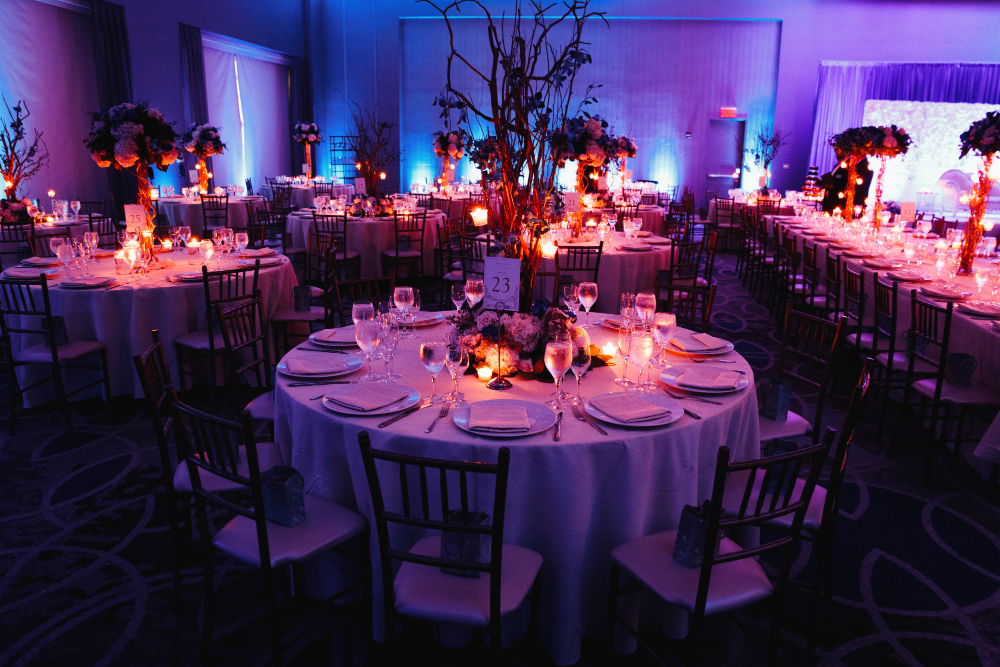 decorated-wedding-hall-with-candles-round-tables-centerpieces